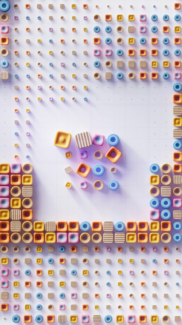 A colorful arrangement inspired by Parametric Architectural Design features small, cube and cylinder-shaped objects in yellow, orange, blue, and pink, spread evenly across a white grid with denser clusters along the edges and a looser pattern in the center.
